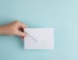 person holding a white envelope