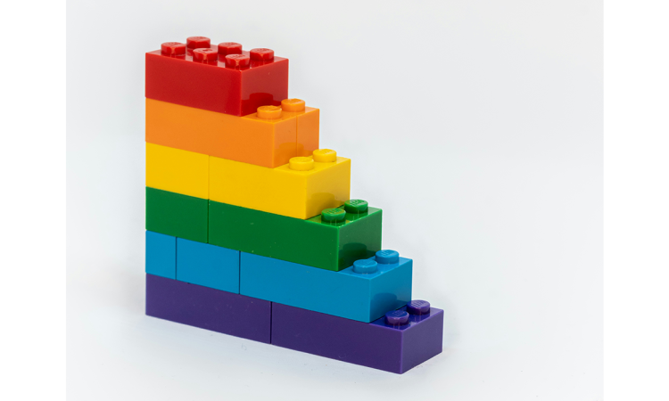 A stack of rainbow-coloured Legos sitting on top of each other